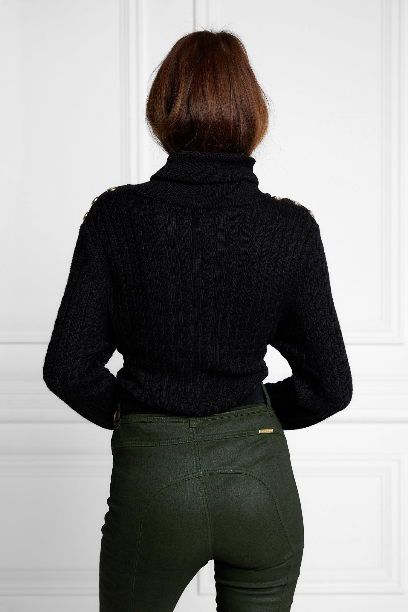 womens cable knit jumper in black with ribbed roll neck cuffs and hem