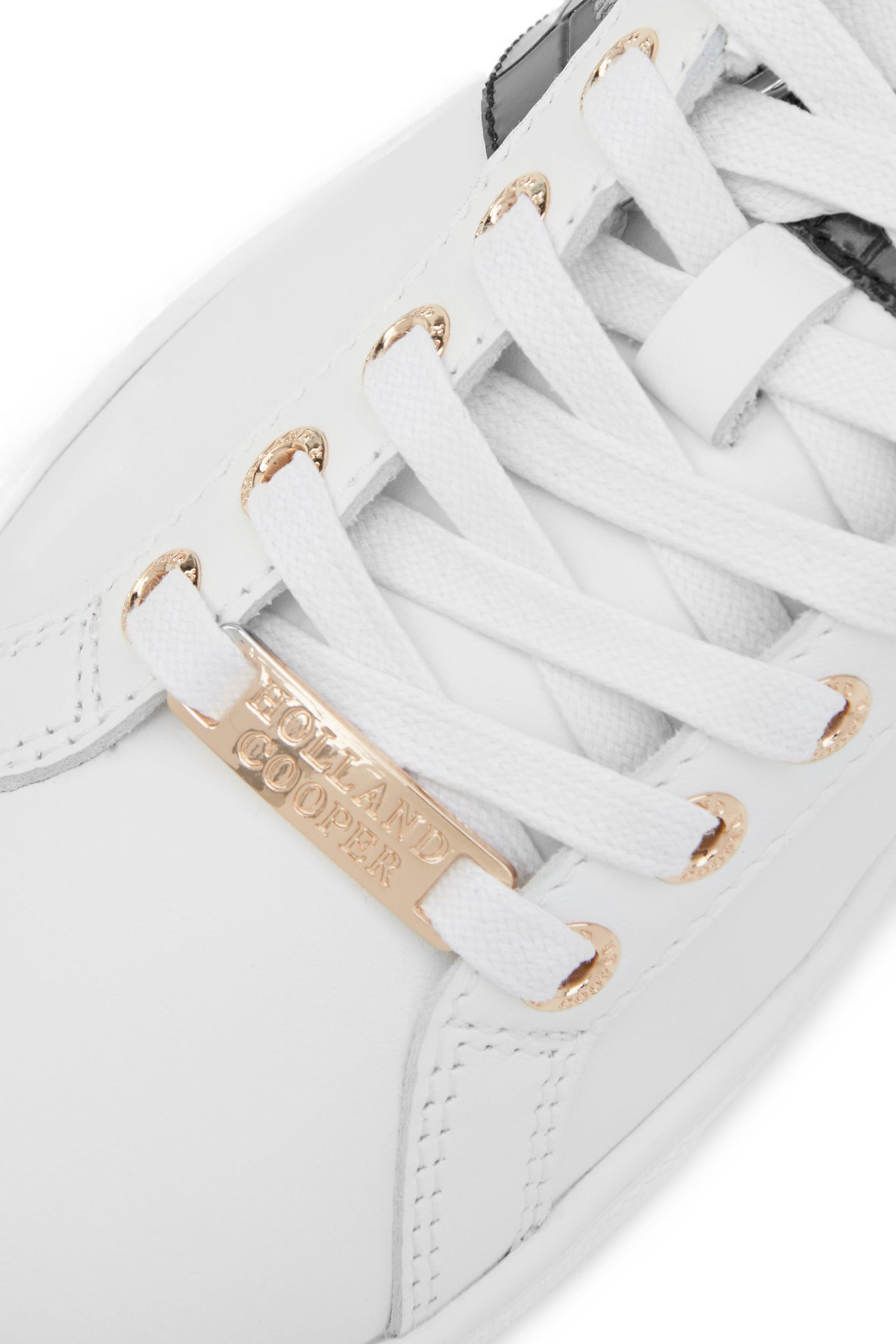 Close up of the white laces with gold hardware