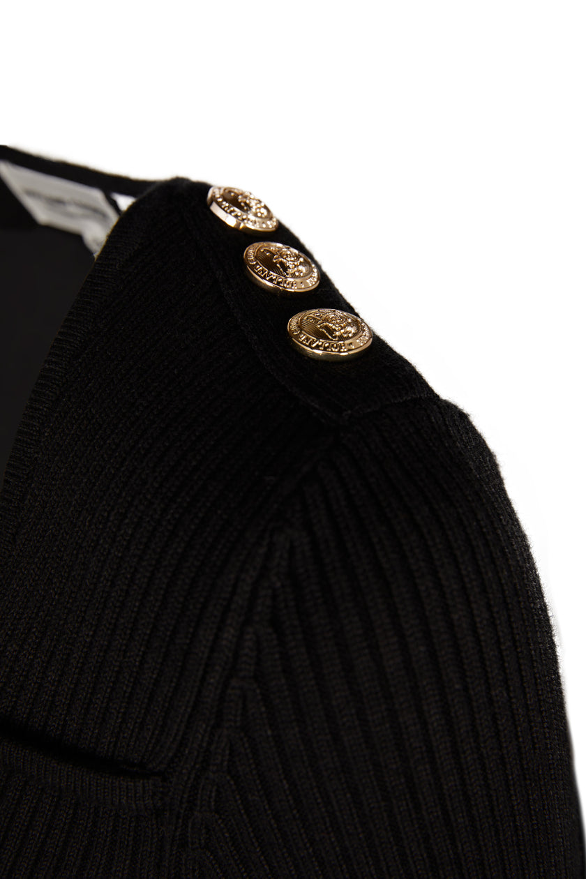 gold button detail across shoulders of a form fitting finely ribbed long sleeved knitted top in black with a sweetheart neckline 