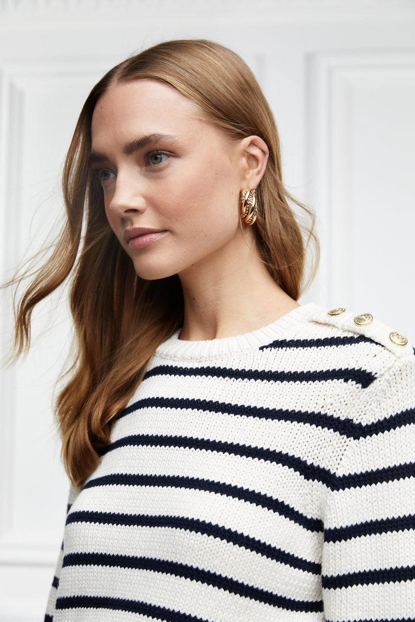 a classic cream and navy breton stripe crew neck jumper with a split ribbed hem and gold button detail on the cuffs and collar