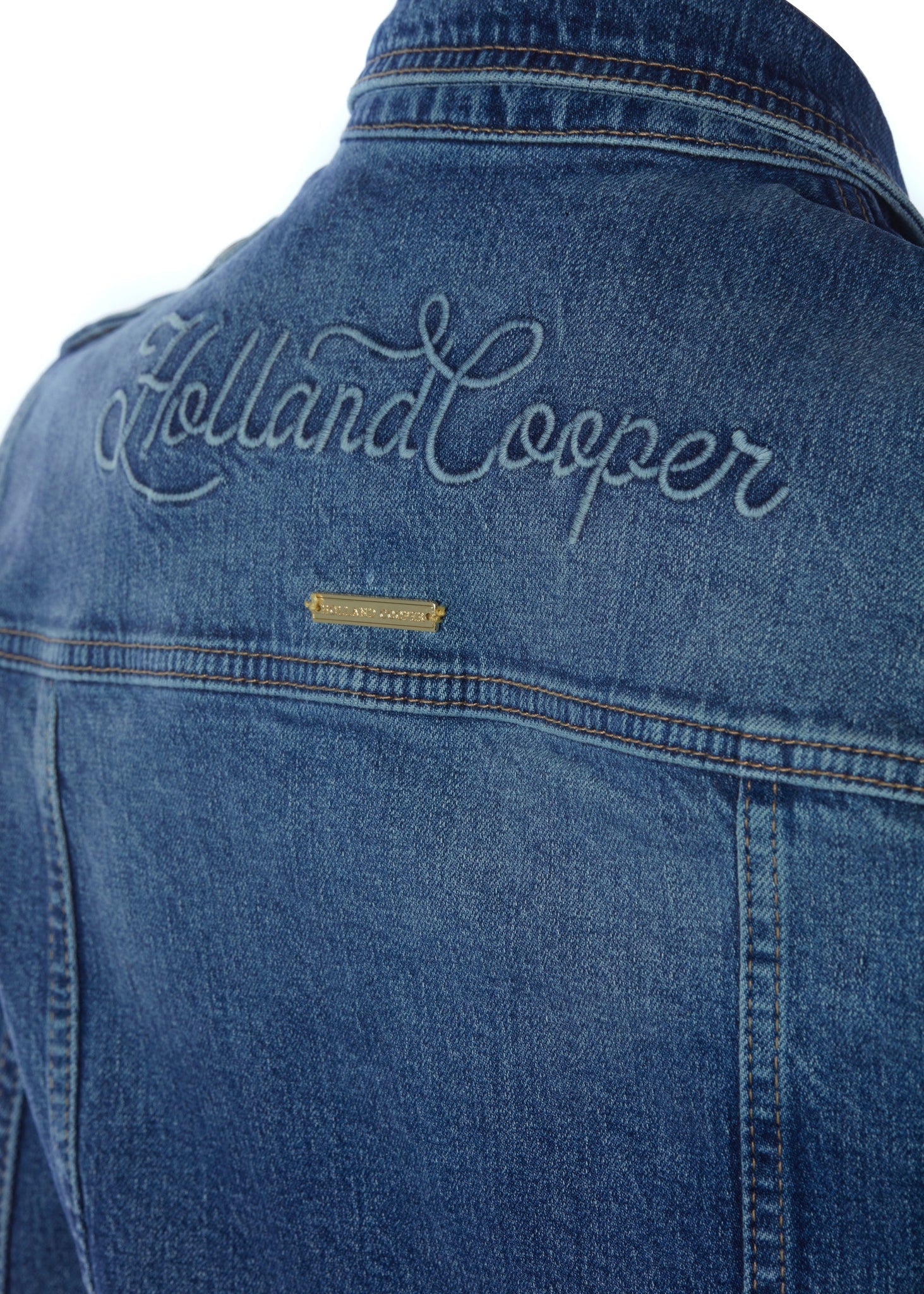 blue embroidery detail across back of classic indigo denim jacket waist length with gold buttons on front, pockets and cuffs with holland cooper embroidery on back