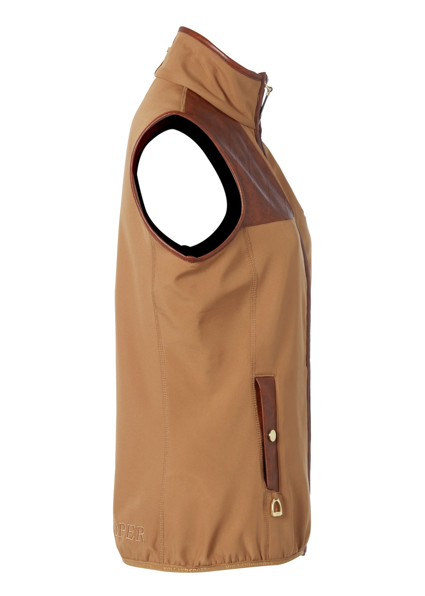 side of womens light brown gilet with dark brown leather seams along the arm holes pockets and down the zip with a gun patch on the shoulder and an embroidered logo