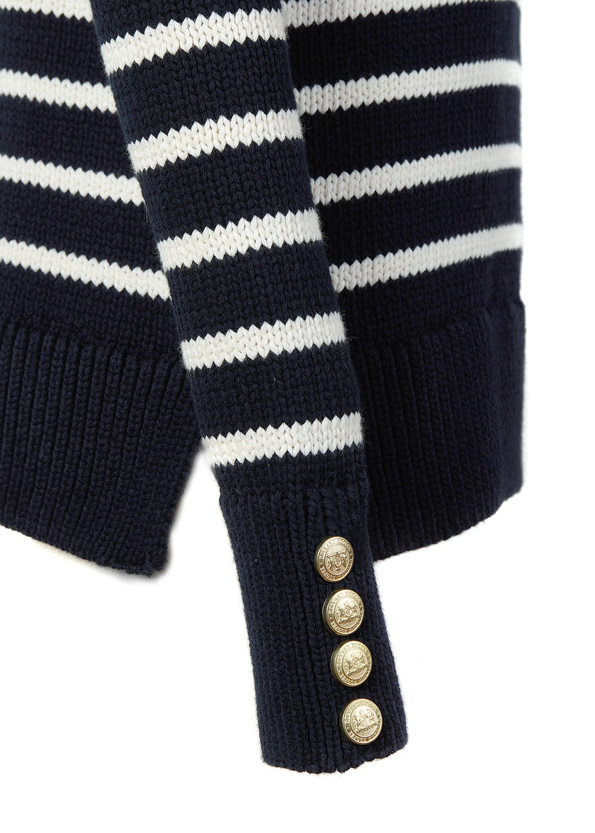 gold button detail on cuff of a classic navy and cream breton stripe crew neck jumper with a split ribbed hem and gold button detail on the cuffs and collar