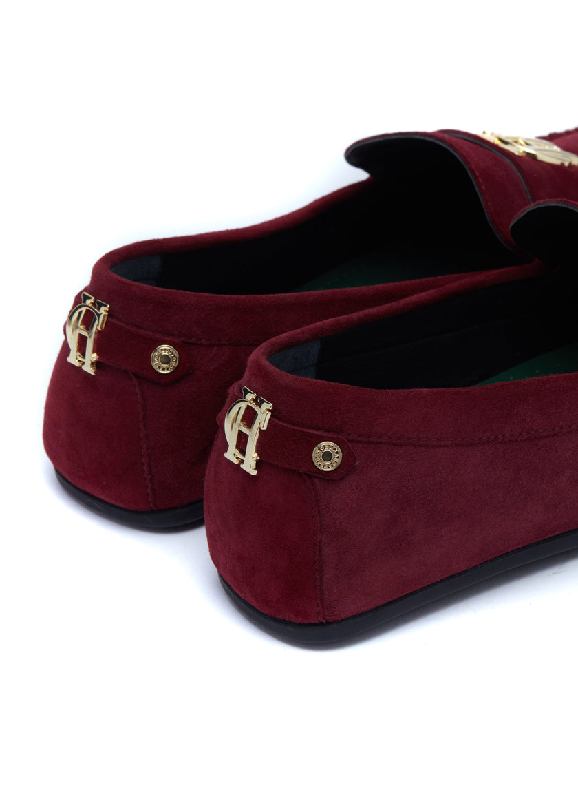 Back of classic deep red suede loafers with a leather sole and gold hardware