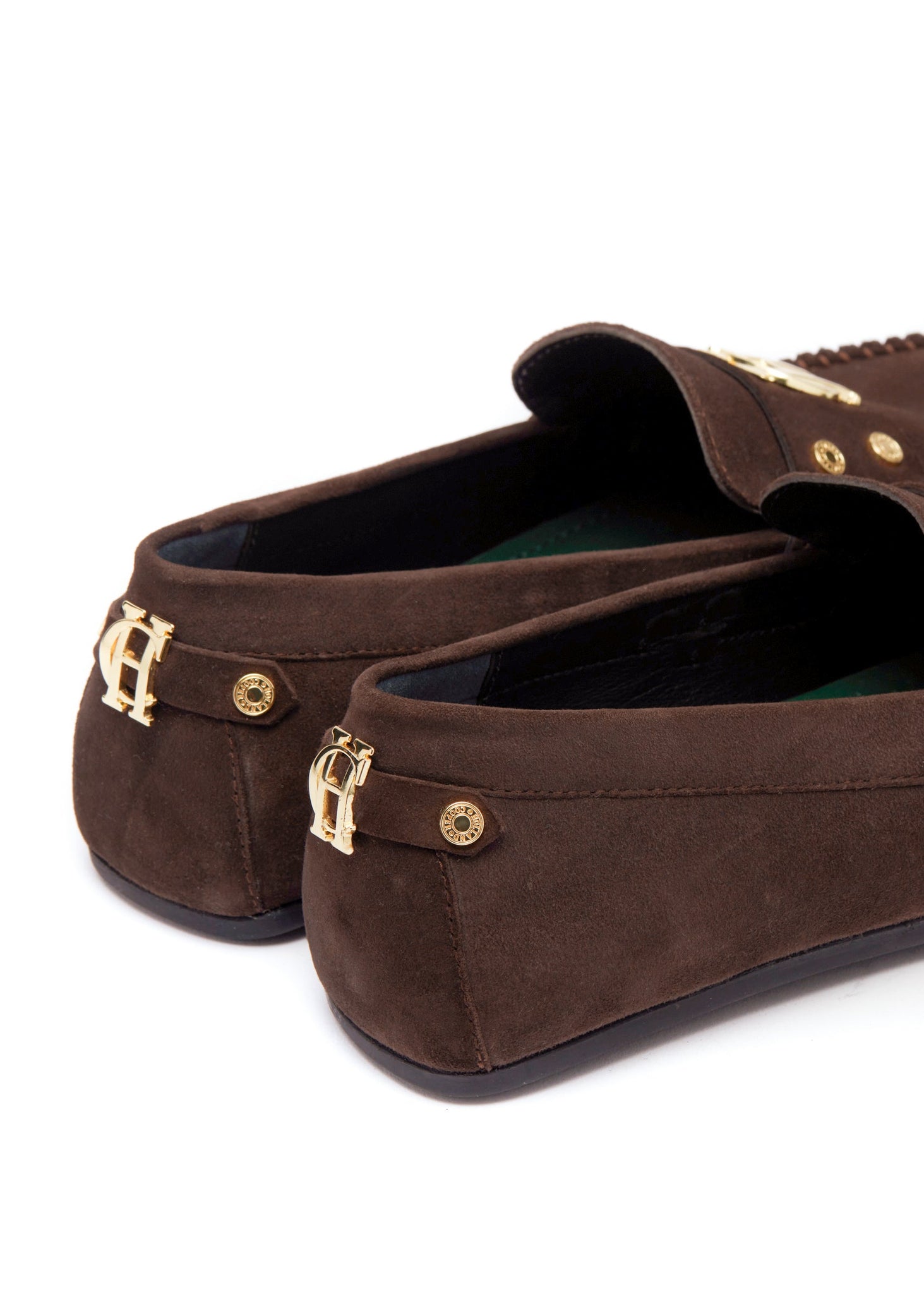 back of classic brown suede loafers with a leather sole and gold hardware