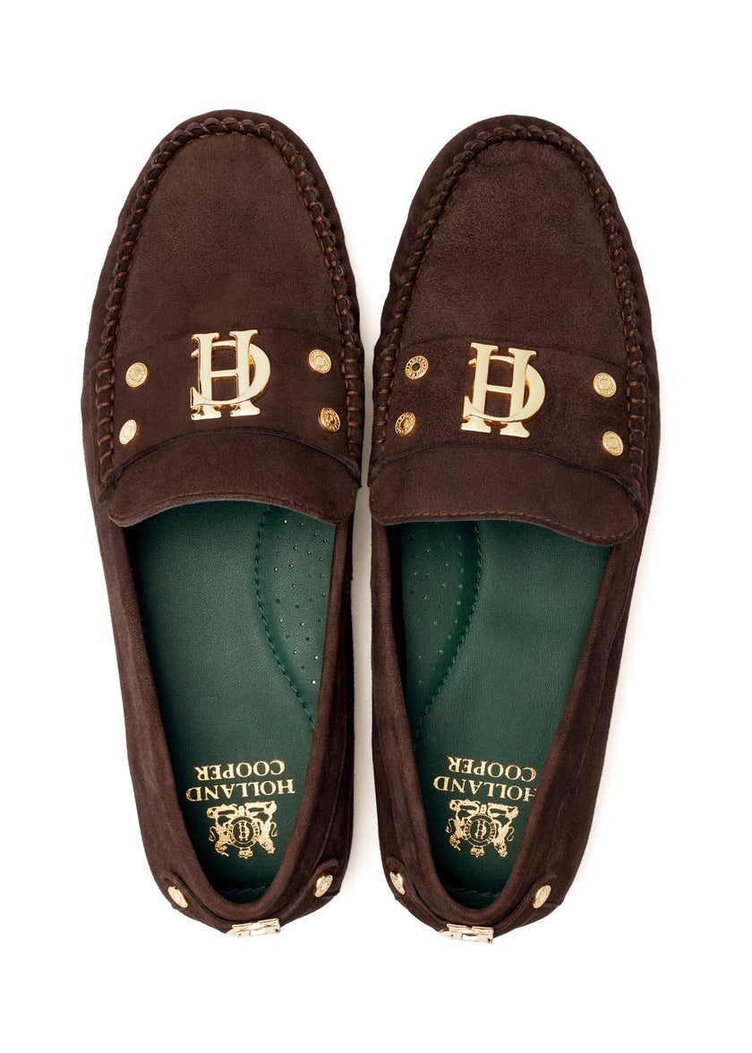 Classic brown suede loafers with a leather sole and top stitching details and gold hardware with a dark green inner sole and gold foil branding