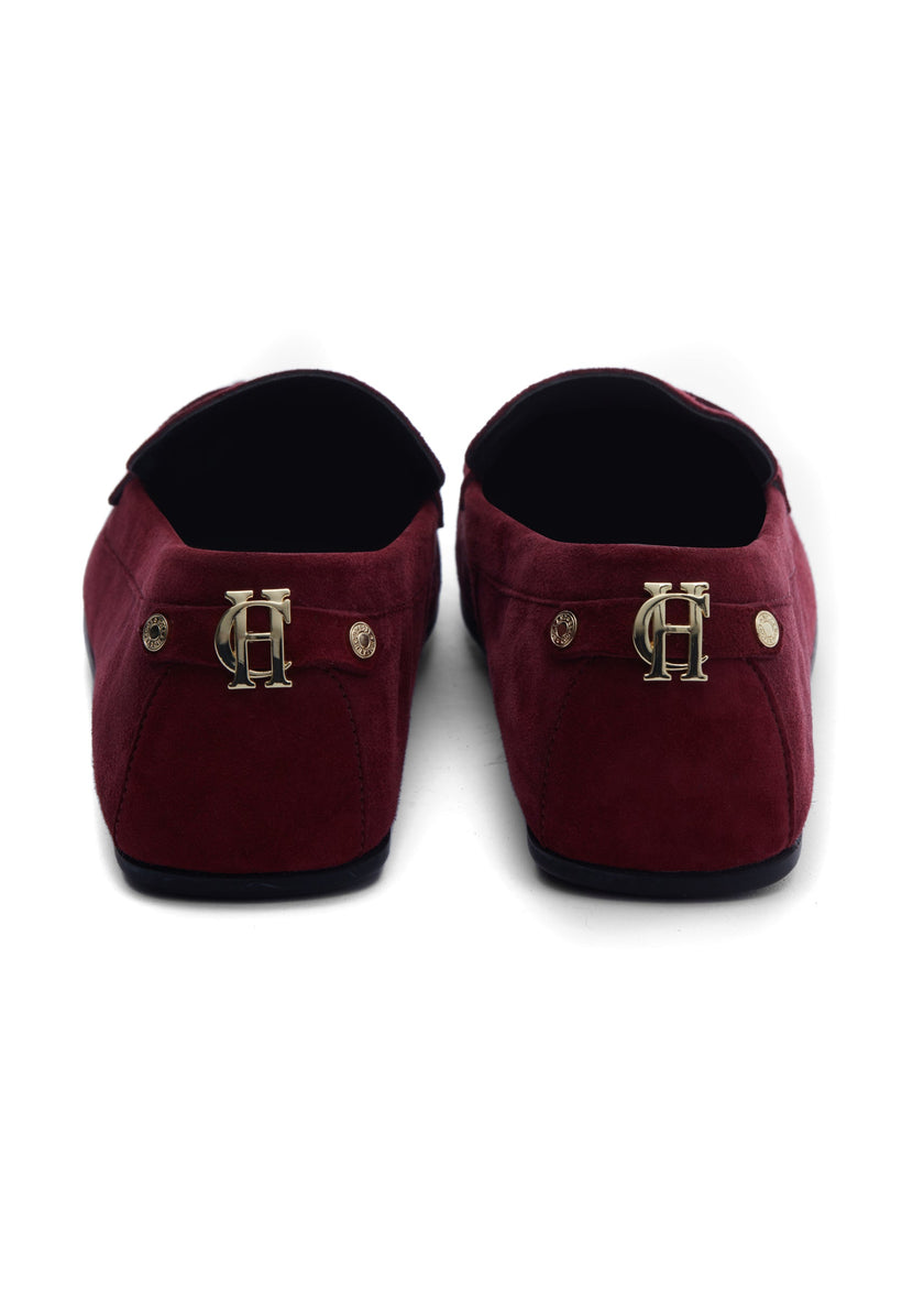 Back of classic deep red suede loafers with a leather sole and gold hardware