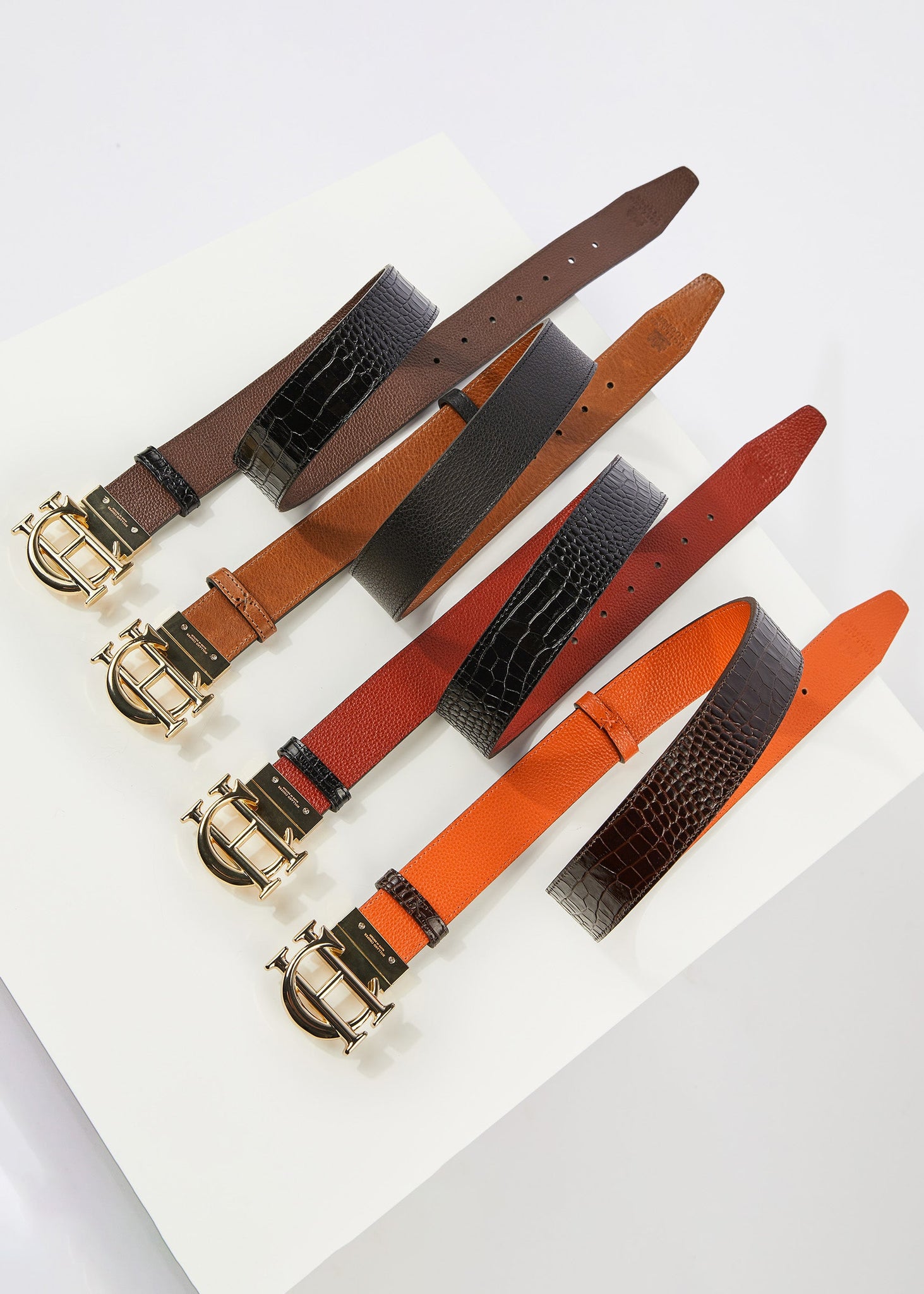 comparative image of all reversible belt colourways, chocolate/black croc, black/tan, red/black croc and orange/chocolate croc