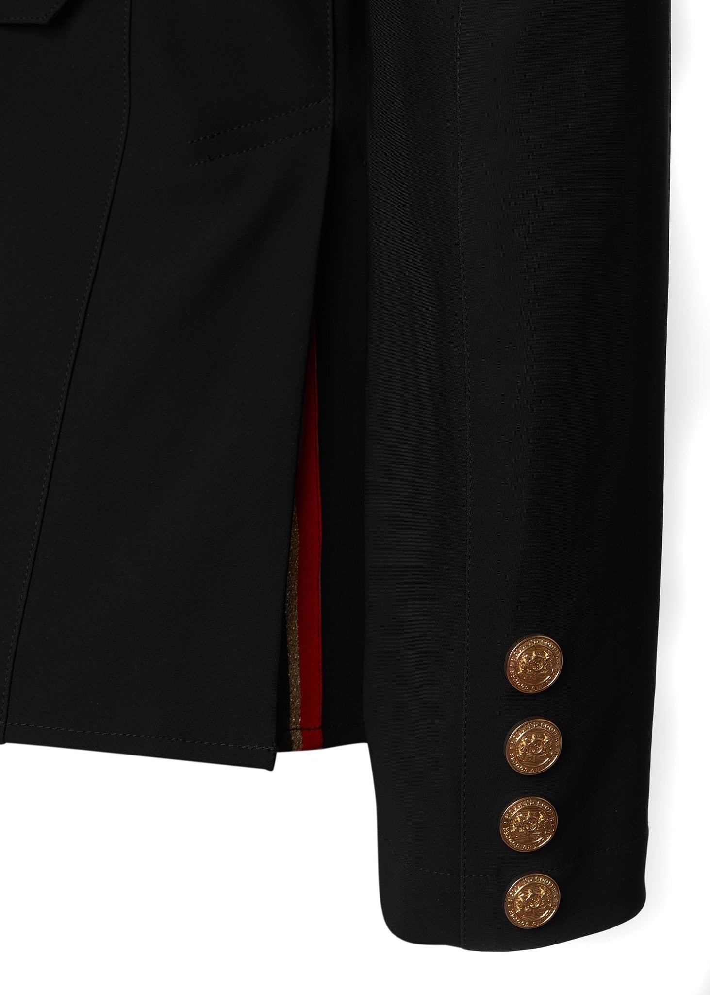 sleeve detail of womens black competition jacket with gold hardware 