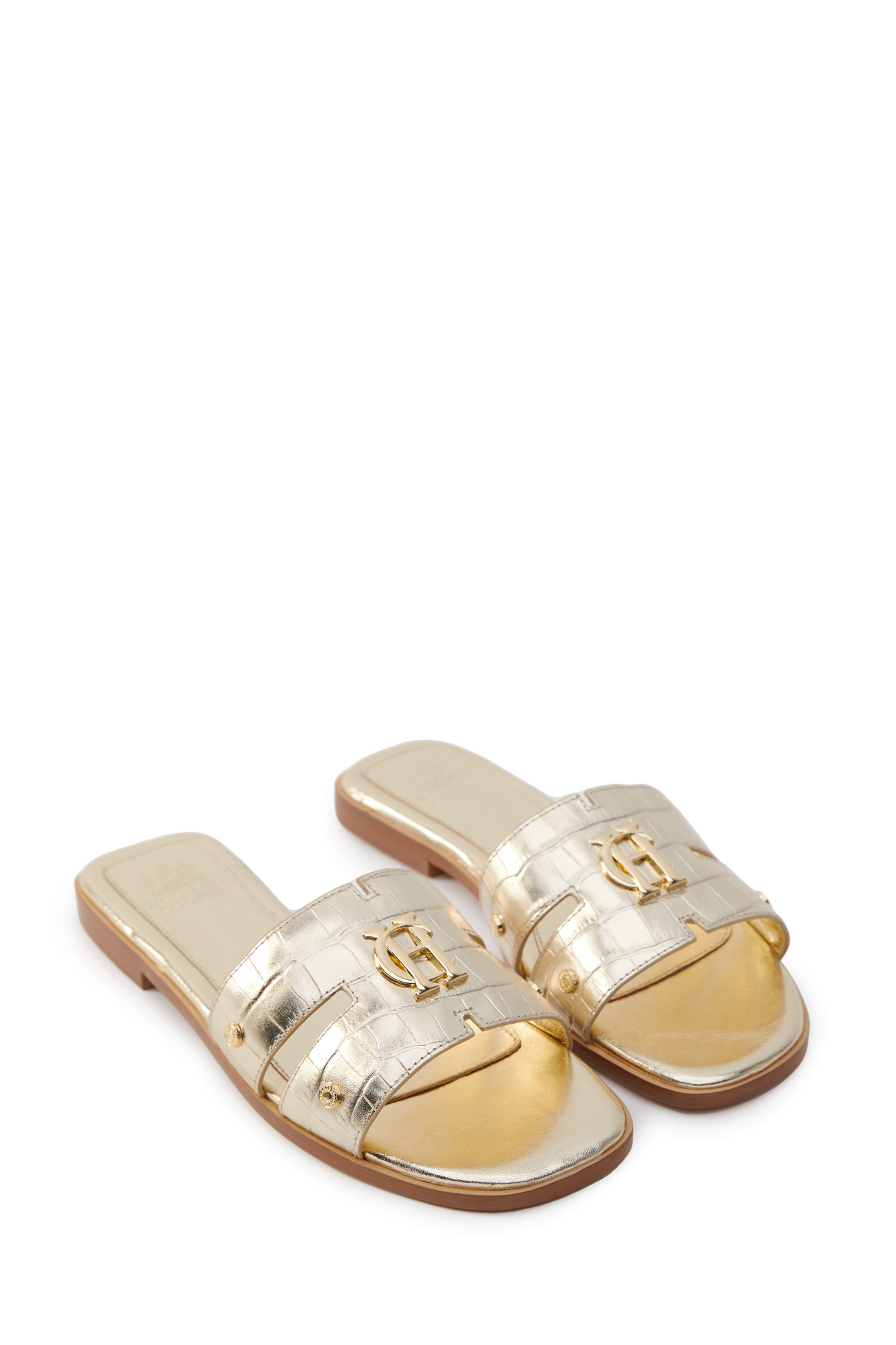 Gold croc embossed leather sliders with a tan leather sole and gold hardware.