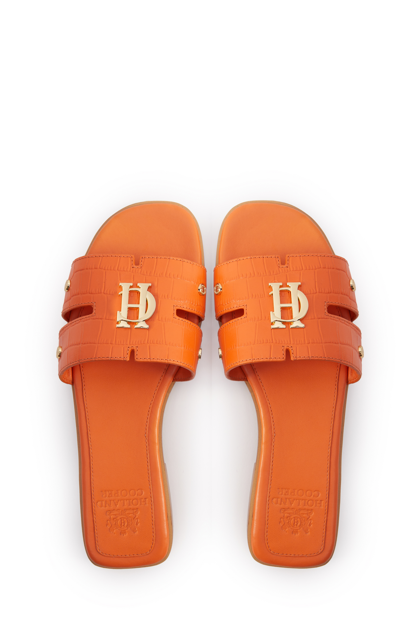 Birds eye view of orange croc embossed leather sliders with a tan leather sole and gold hardware. 