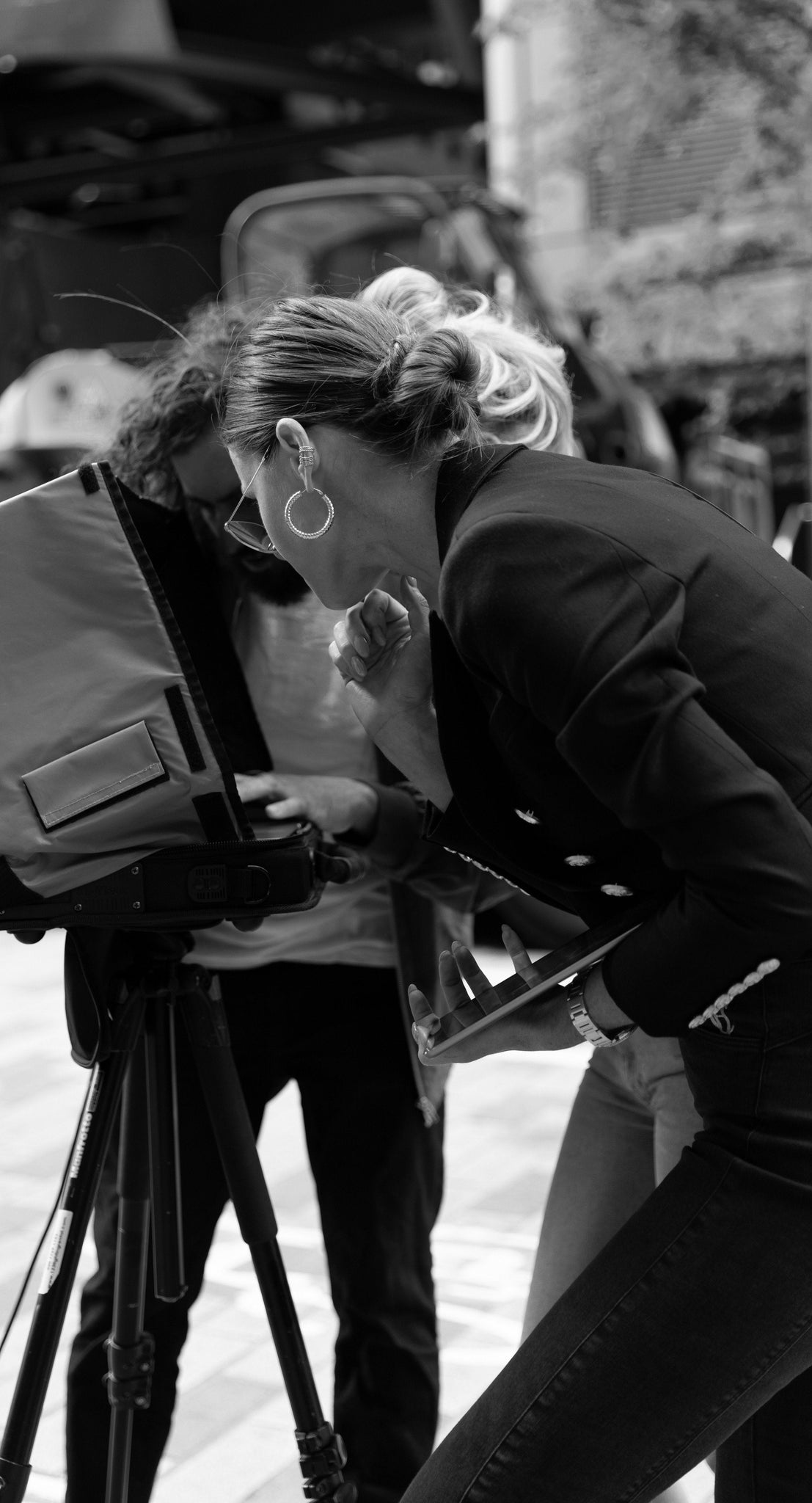 Black and white image of Jade Holland Cooper, owner of Holland Cooper, stood looking into shoot screen